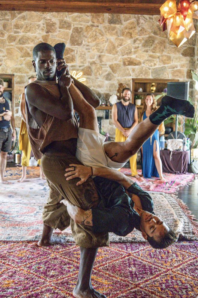 Acro carry between two practitioners