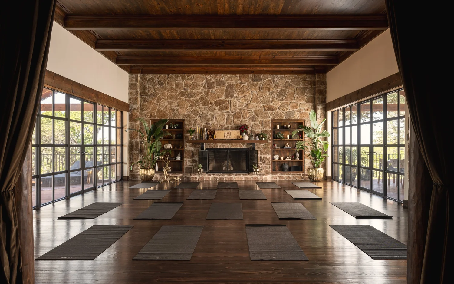 The same room transformed for movement practice, yoga mats laid across dark wood floors
